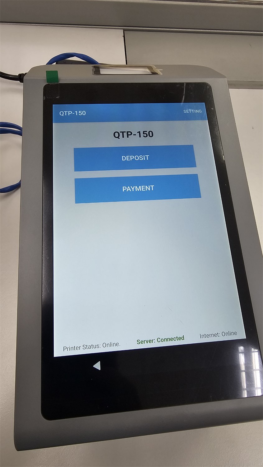 QTP-150 installed at a counter showing Deposit and Payment service buttons, with printer, server and internet status shown as online